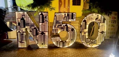 The N50 metal cast installation by Graphic Arts, lit from within at night