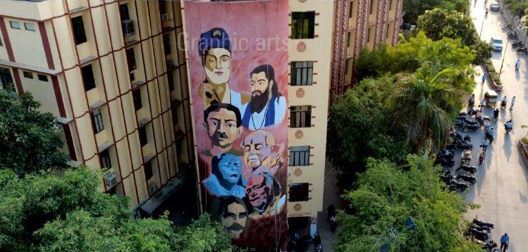 A second facade mural seen from above, with the street below giving the scale